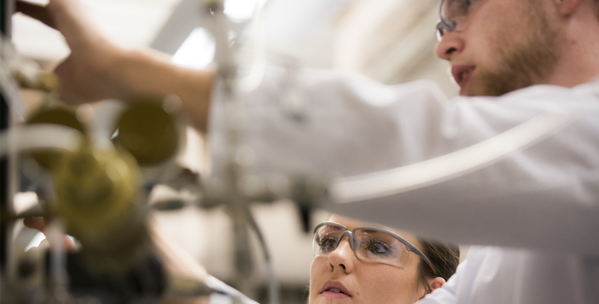 photo of two students working together in a lab