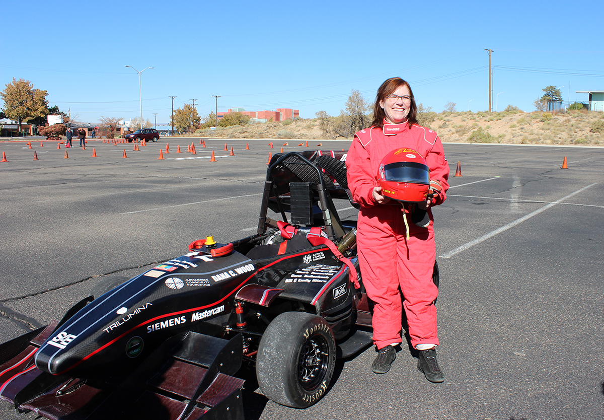 photo of UNM president Stokes with race car