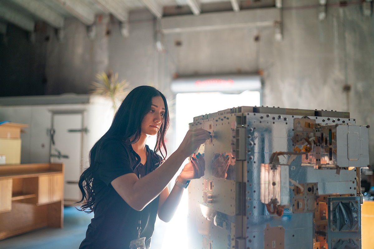 photo: A woman works on a satellite