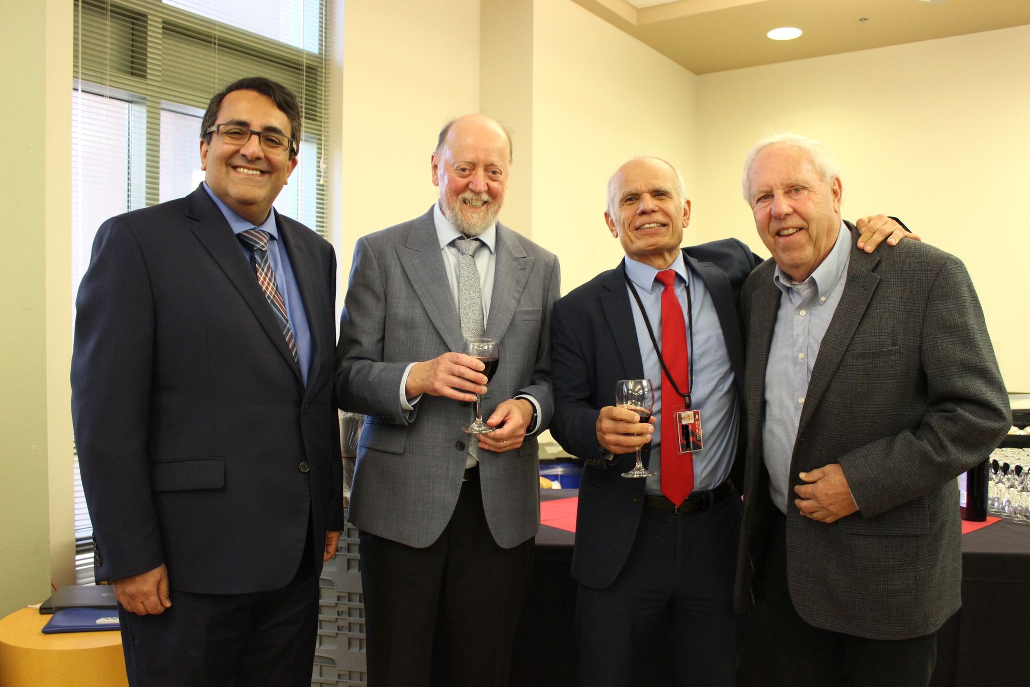 photo: Christodoulou with (left to right) Arash Mafi, interim dean of the College of Arts and Sciences; Turing Award winner and UNM alumnus Jack Dongarra; and Frank Gilfeather, emeritus professor from the Department of Mathematics and Statistics, in October 2022 during the UNM Jack Dongarra celebration at Centennial Engineering Center.