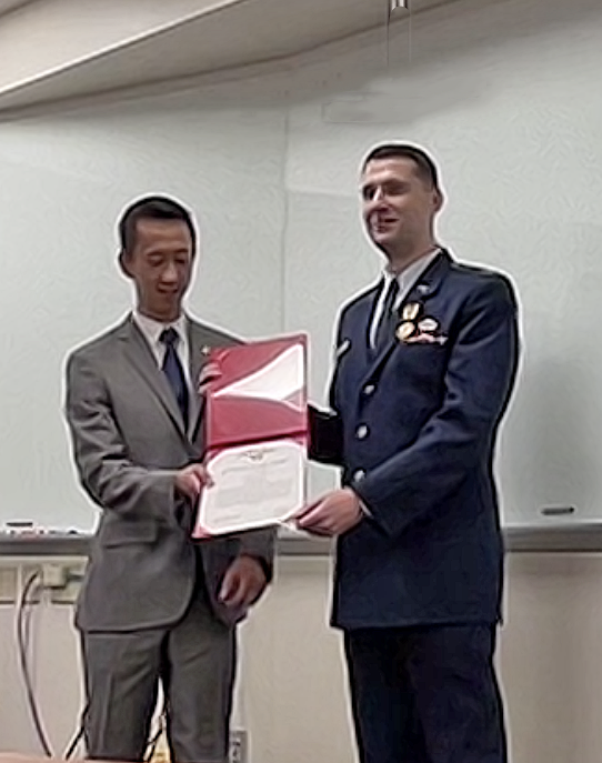 photo: Michael Sherburne receives the Air and Space Commendation Medal and certificate from Elvis Nguyen from Johns Hopkins APL.