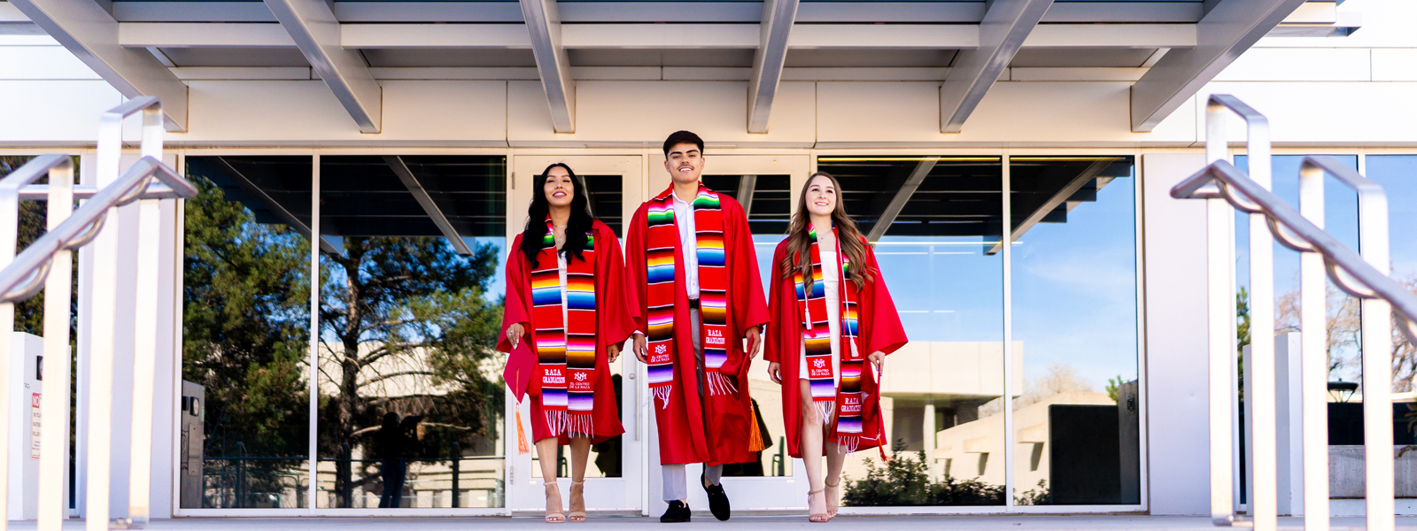 photo: 3 graduates in convocation attire