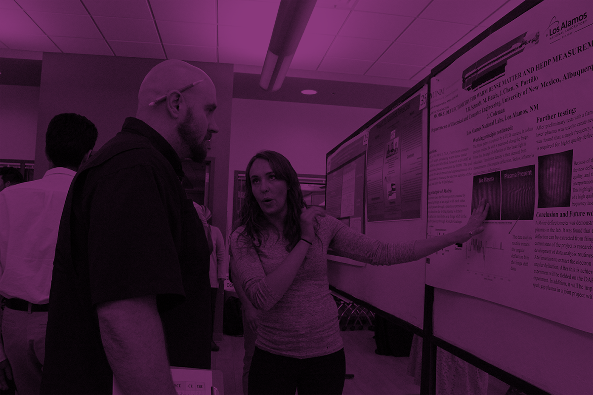 photo of a female student presenting her research poster.