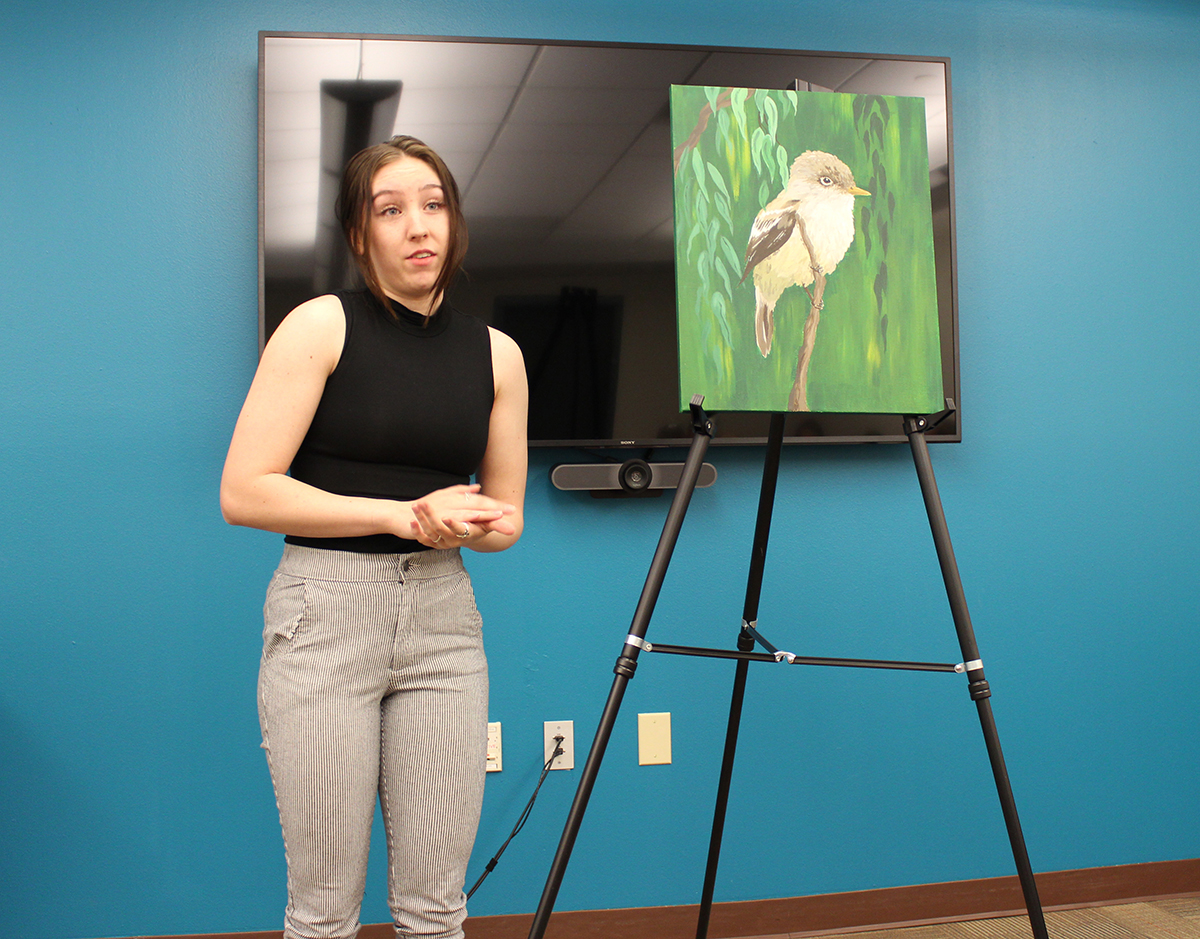Photo: Kamryn Zachek, an economics student, discusses “Conservation of the Middle Bosque: How a Return to The Rio Grande’s Roots Can Revitalize Endangered Species in New Mexico.”