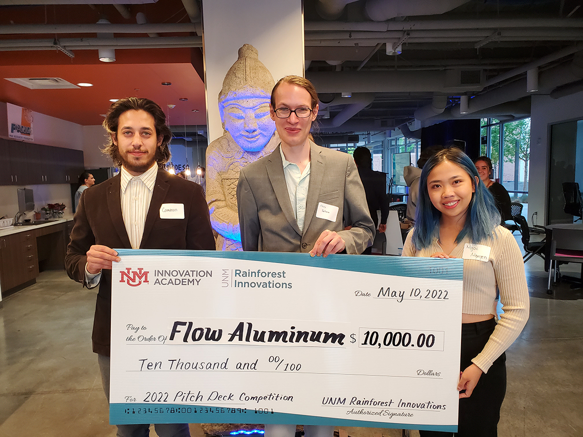 photo:3 winners holding a giant check