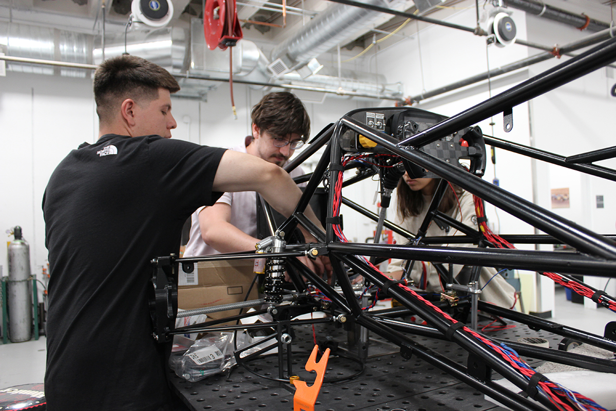 photo: Students at work on the FSAE car