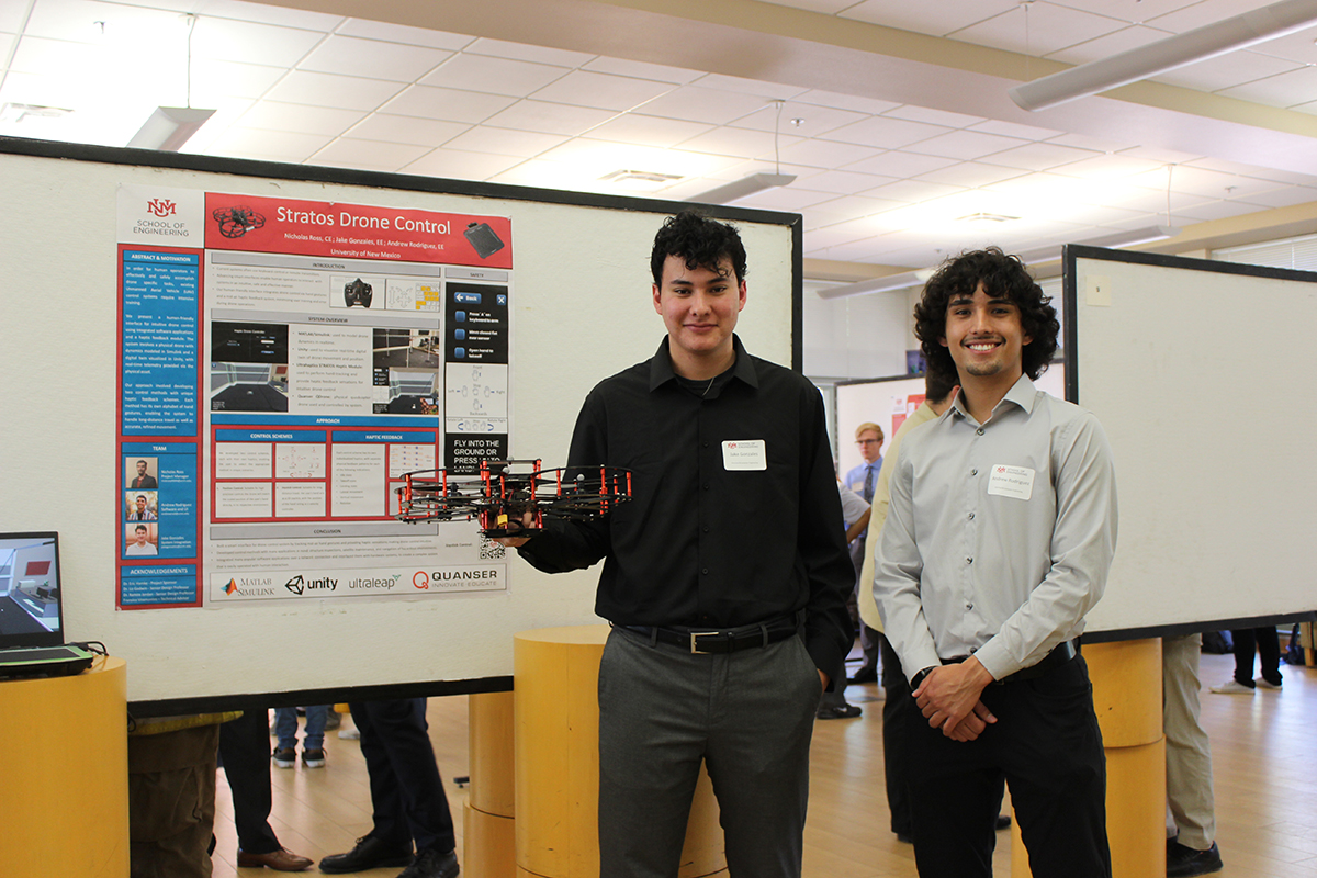 photo: Team members Jake Gonzales and Andrew Rodriguez stand by their poster, Stratos Drone Control, which won second place in the poster competition.