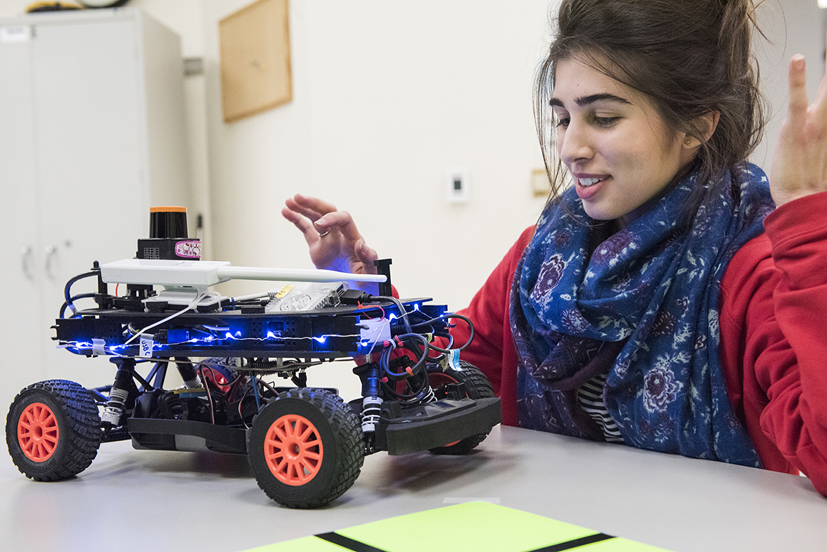 a student demonstrates her robotic vehicle